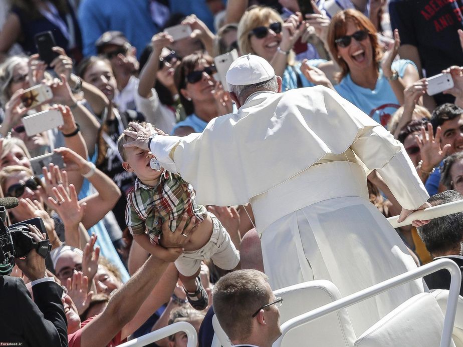 پاپ در حال تبرک دادن به یک کودک